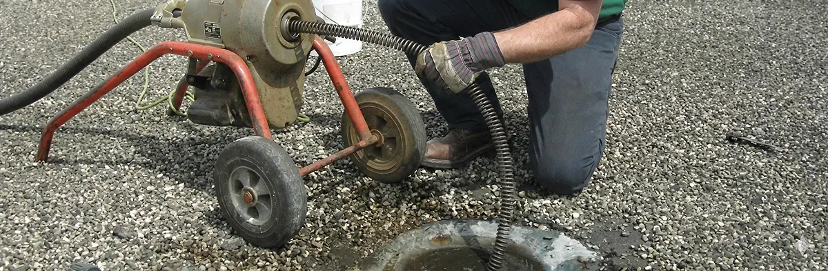 sewer rodding technician actively removing blockages from a sewer line in Jacksonville, FL